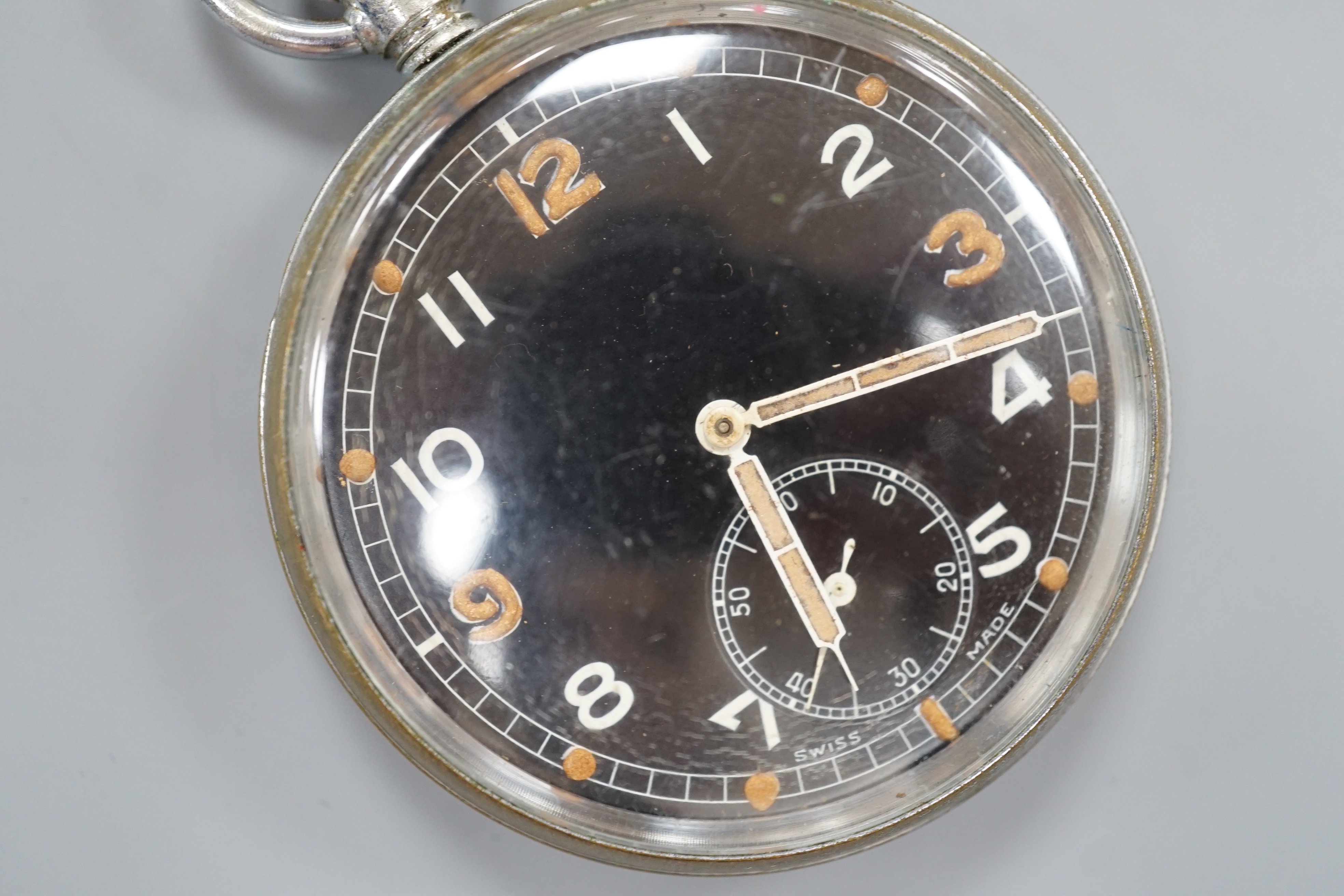 A military issue chrome cased keyless pocket watch, with black Arabic dial and subsidiary seconds, the case back engraved with broad arrow G.S.T.P. over Q 8315.